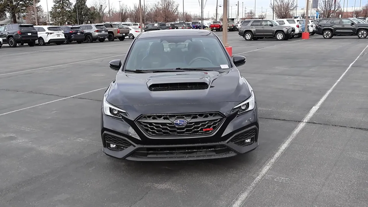 Subaru WRX TS front view showing hood scoop, grille and overall stance in a parking lot.
