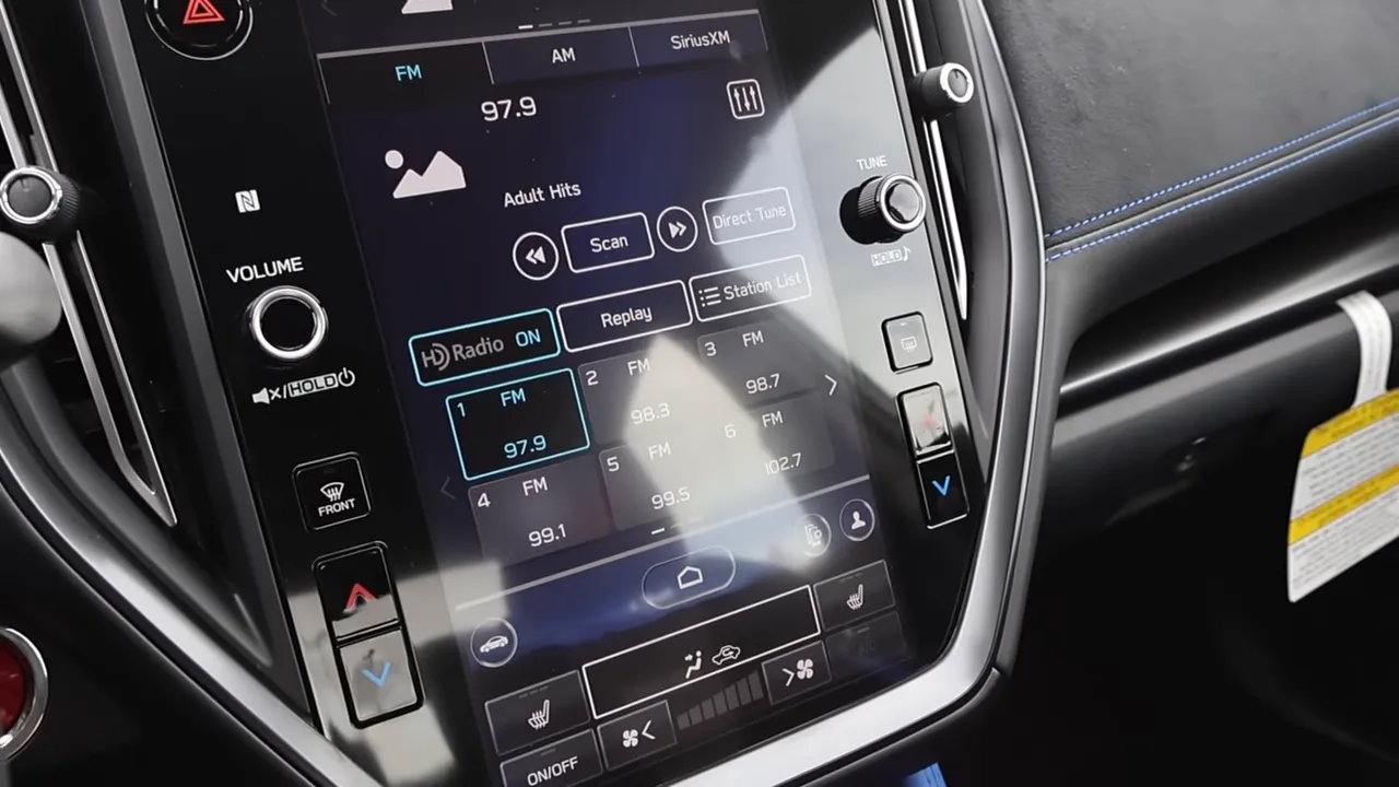 Close-up of Subaru WRX TS infotainment touchscreen with radio presets and climate controls