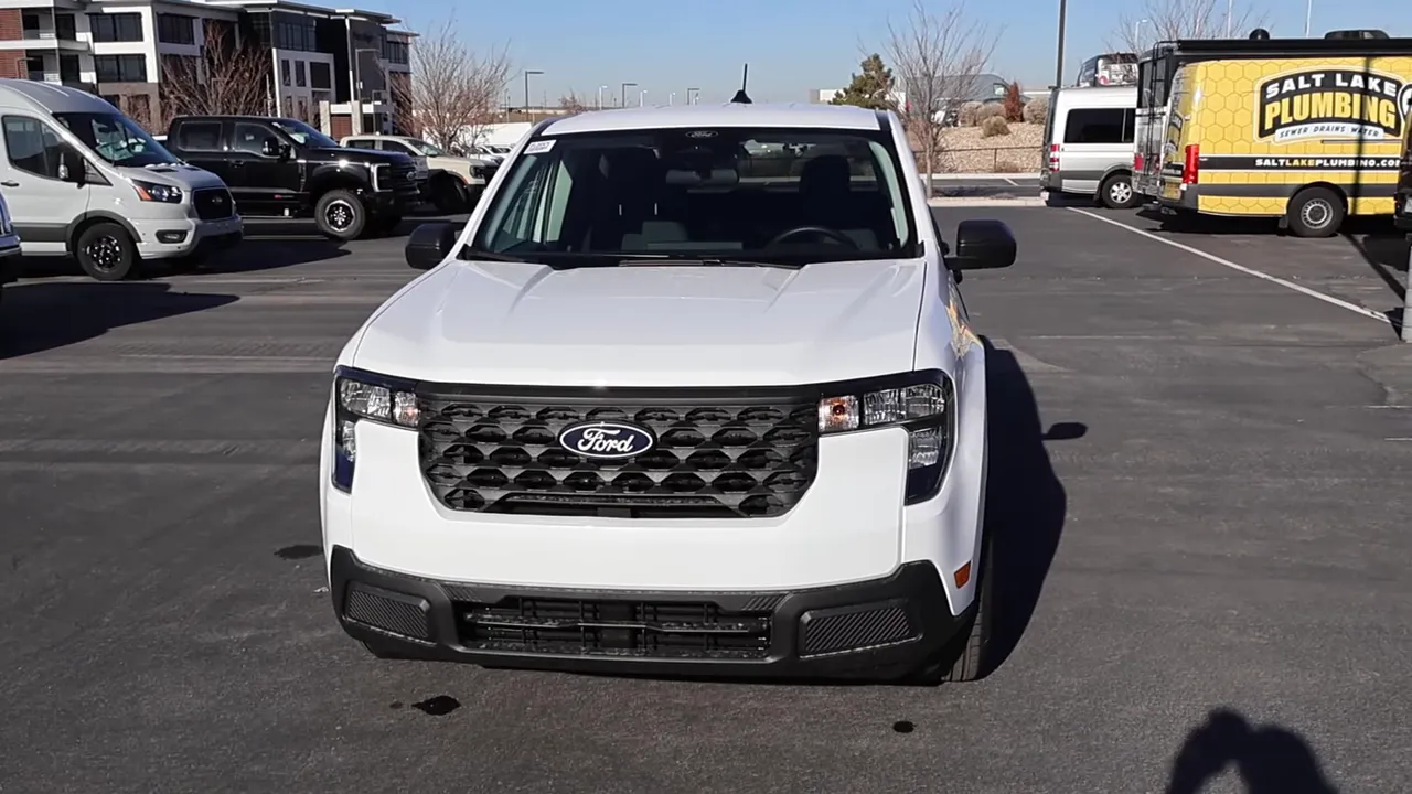 Front-on shot of 2026 Ford Maverick Hybrid XL showing grille, headlights, hood lines and unpainted bumper