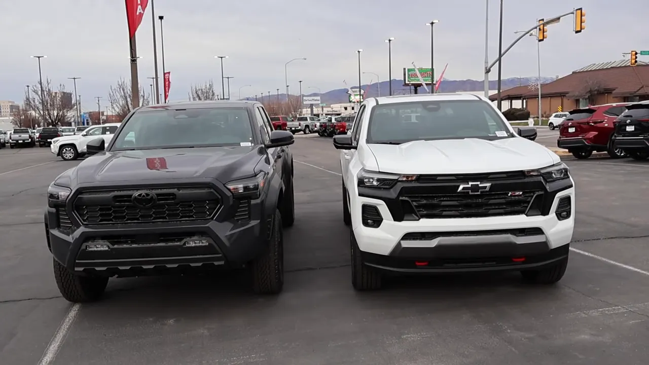 2026 Toyota Tacoma TRD Off-Road and 2026 Chevy Colorado Z71 parked side-by-side front view