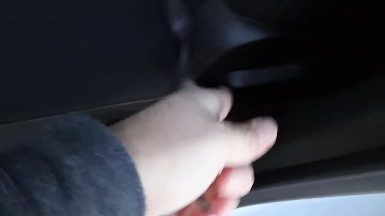 Hand operating interior handle to open the manual rear window of the GMC Canyon