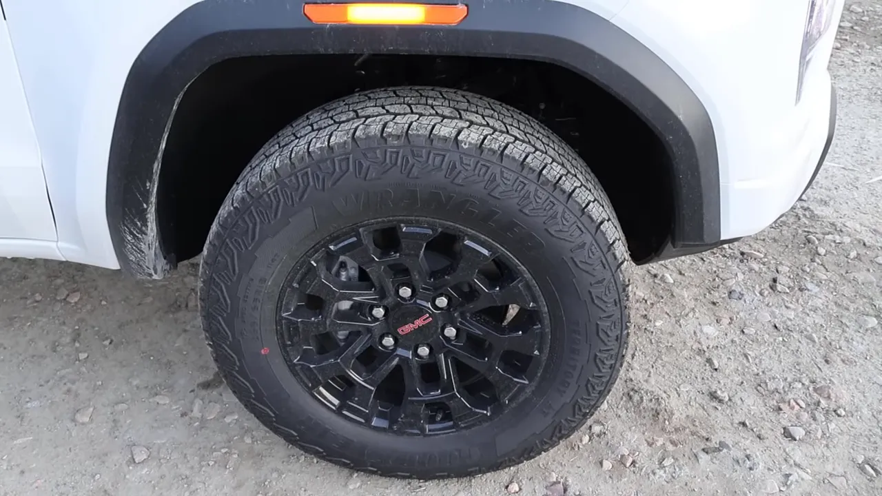 GMC Canyon Elevation black alloy wheel and all‑terrain tire close-up