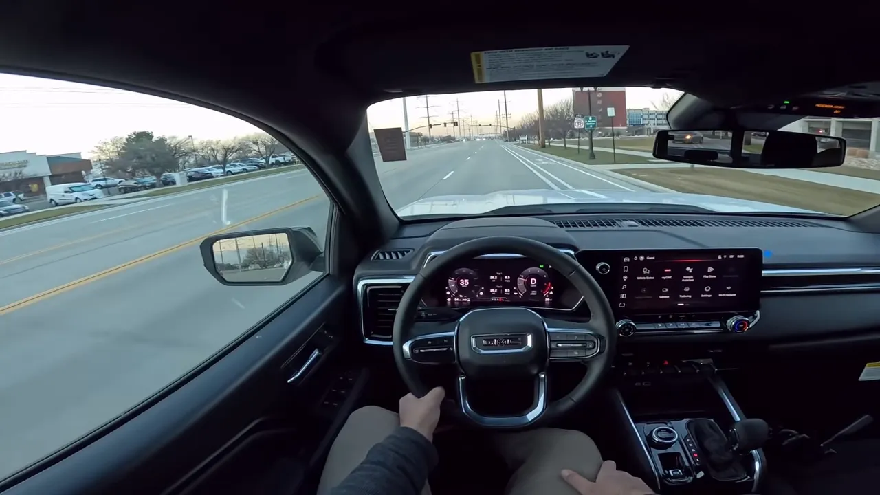 Balanced GMC Canyon driver view showing digital instrument cluster and clear road ahead