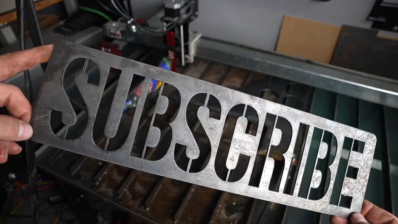 Steel plate with 'SUBSCRIBE' cut out using plasma CNC