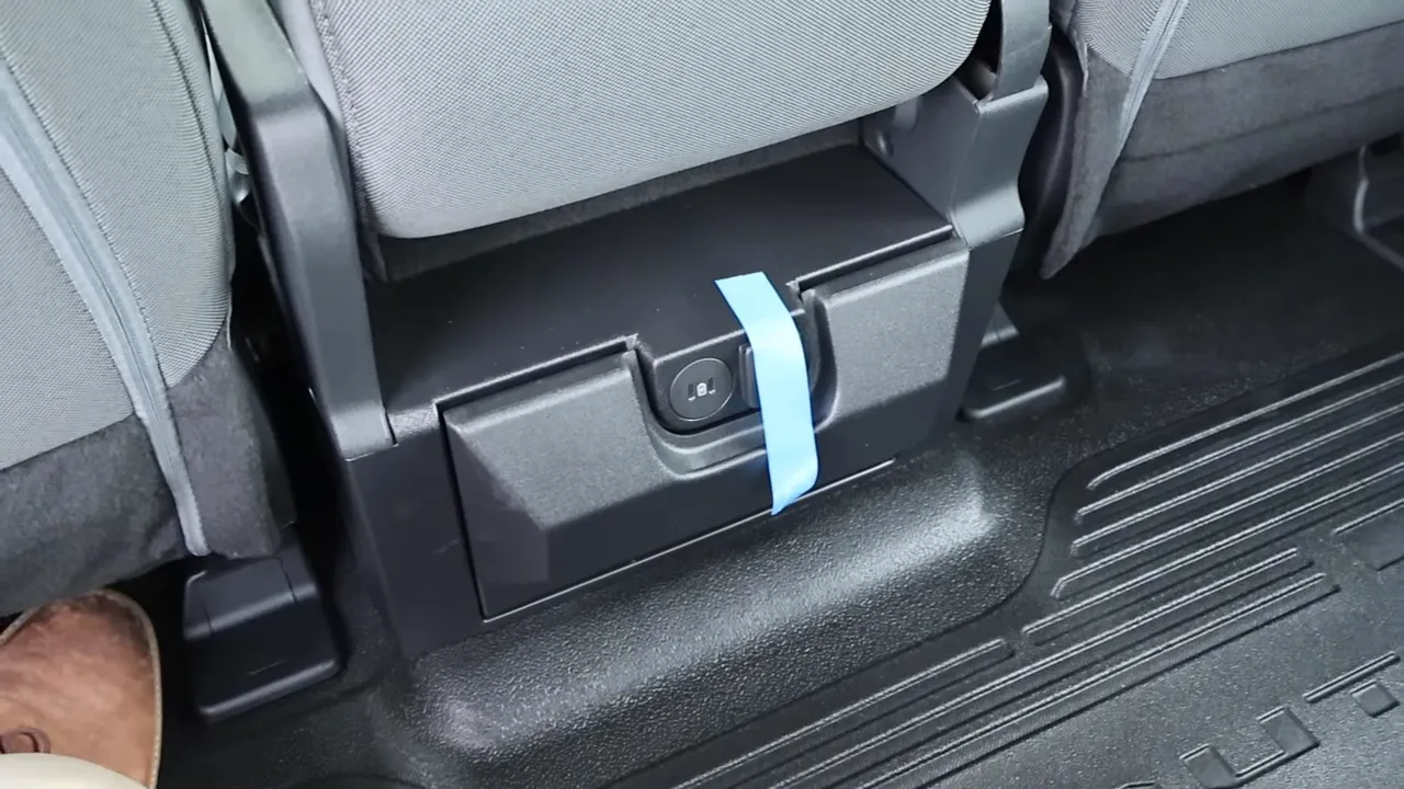 Under-seat storage box with rear power outlet in the 2026 Ford F-250 crew cab