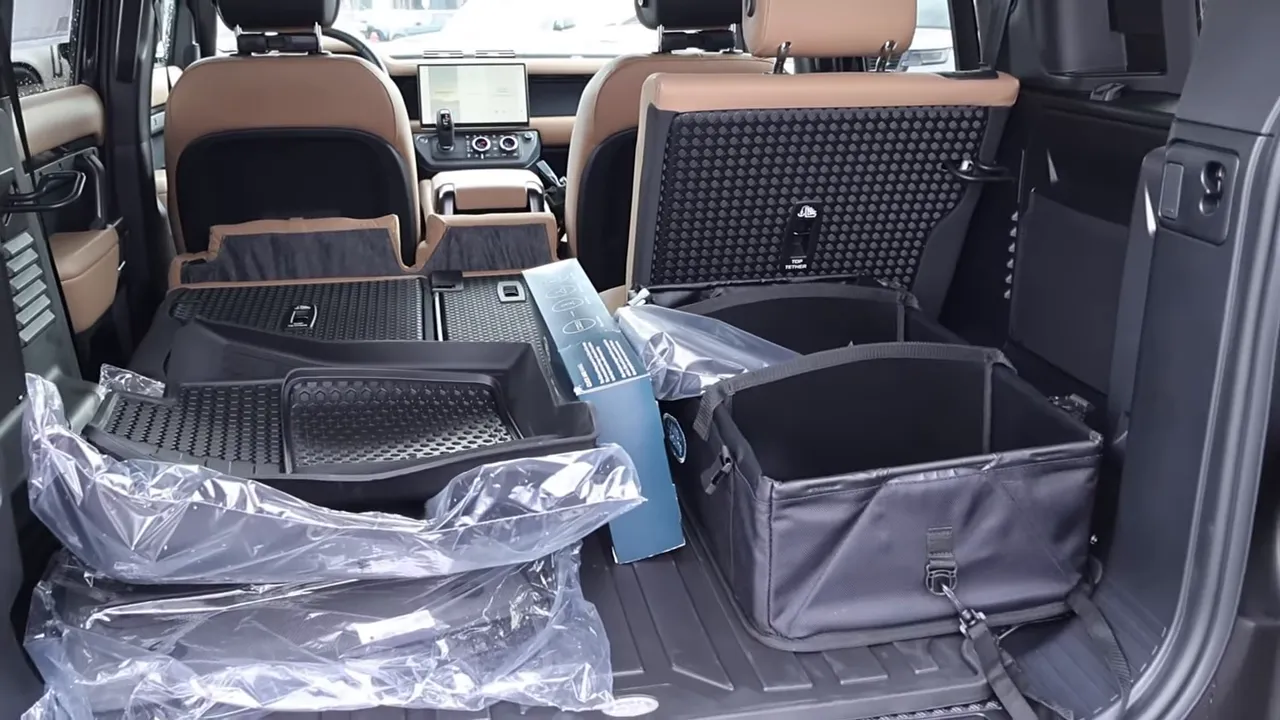 Defender 110 rear cargo with folded seats, cargo bins, floor mats and organizers