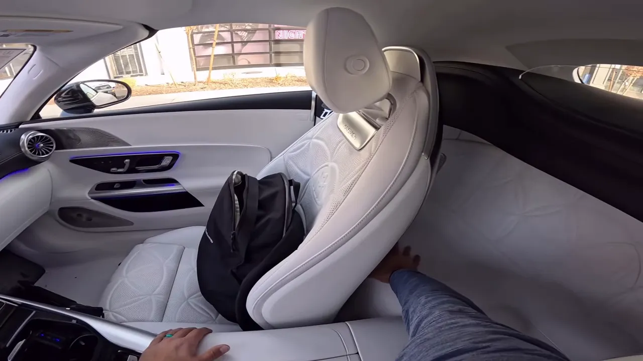 White Maybach SL680 rear leather surface with quilted Maybach pattern and visible stitching, passenger seat in foreground