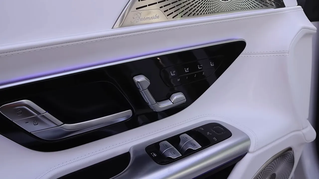 Maybach SL680 door panel close-up showing white leather trim, seat adjustment switches and Burmester speaker grille