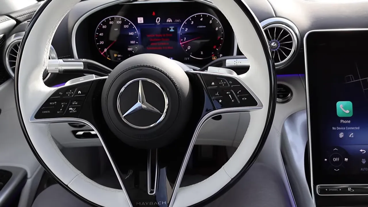 Maybach white steering wheel with digital gauge cluster and portrait infotainment screen visible