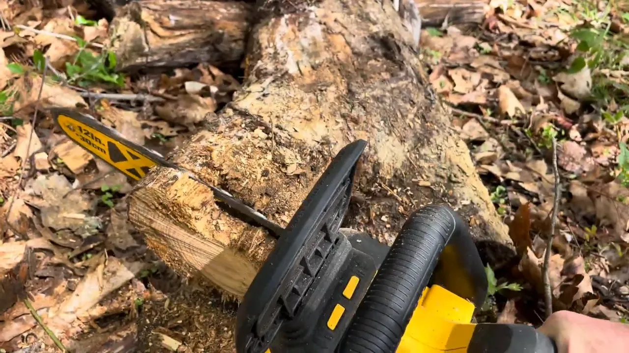 Chainsaw with a 12-inch bar cutting through a thick section of a log