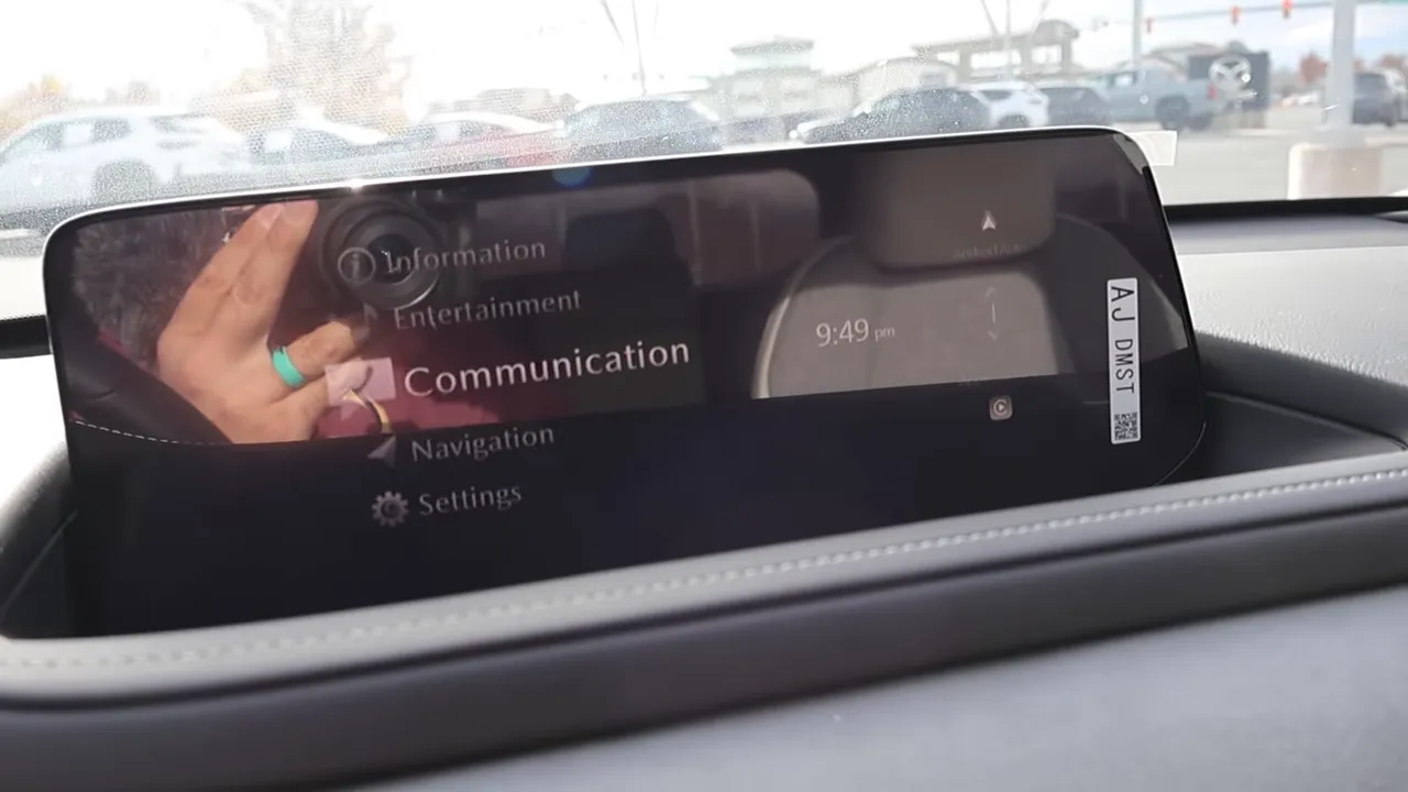 Mazda infotainment menu showing information entertainment communication navigation and settings on recessed display