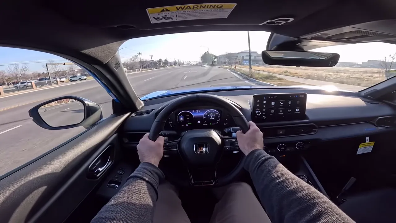 Balanced front interior view of the 2026 Honda Prelude showing steering wheel, paddles and digital instrument cluster