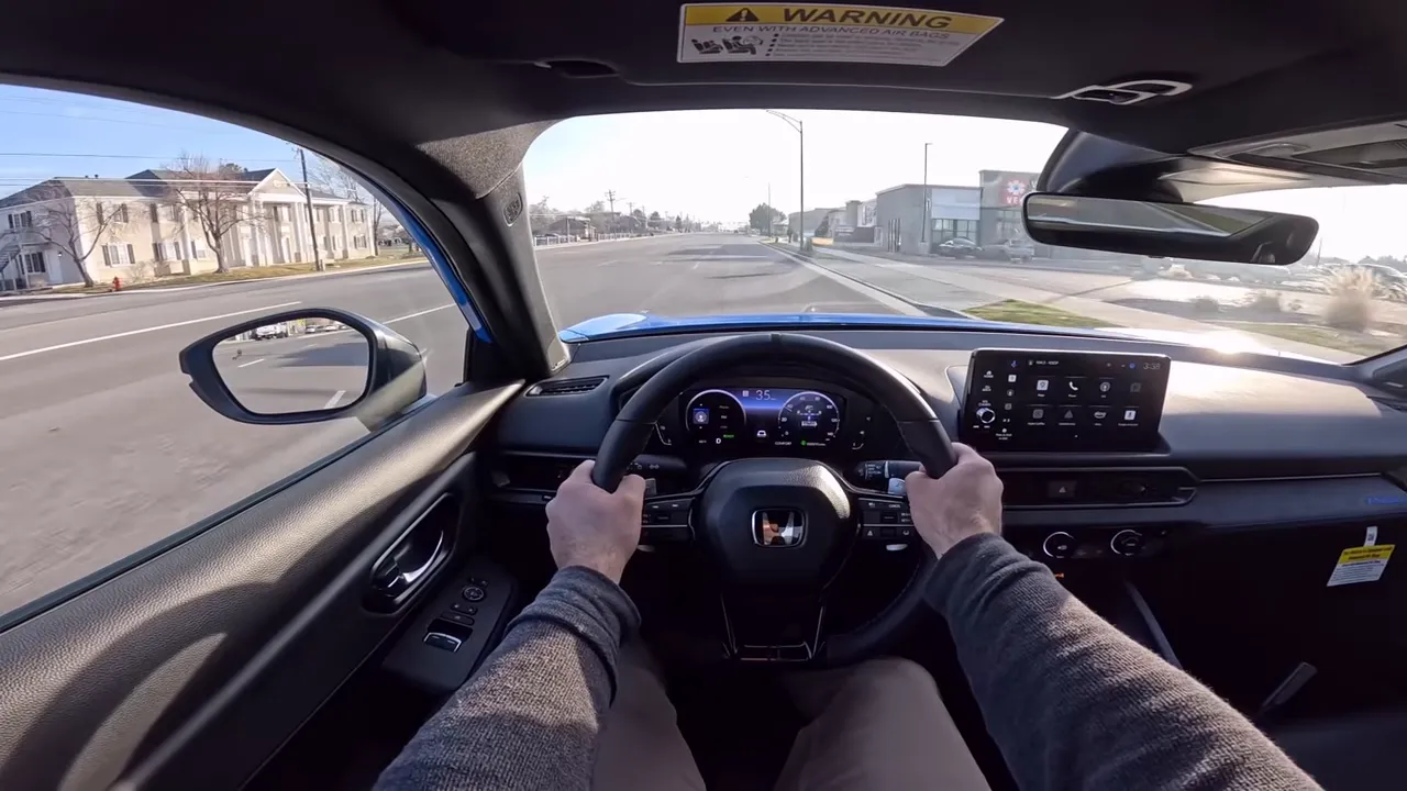Interior cockpit of the 2026 Honda Prelude focused on the steering wheel with visible paddles and the digital instrument cluster.
