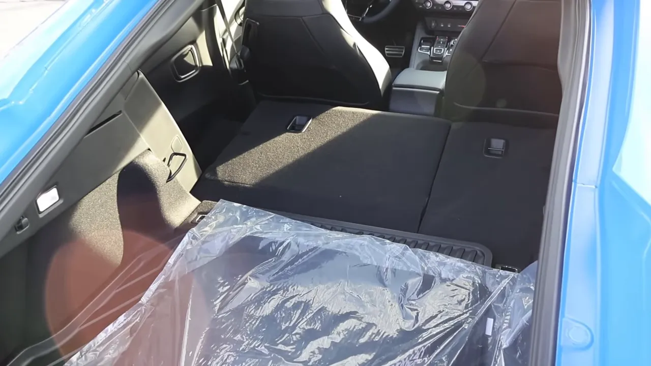 Folded rear seats of the 2026 Honda Prelude with center console visible