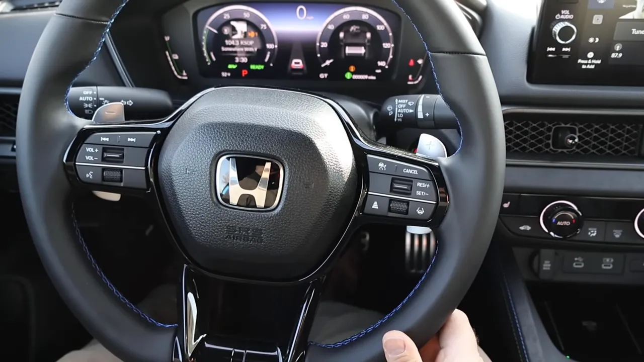 Driver's view of Honda Prelude steering wheel focused on paddle shifters and digital gauge cluster