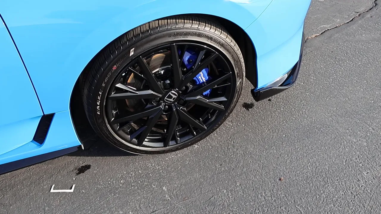 Tight shot of Honda Prelude 19-inch black wheel and blue Brembo brake caliper