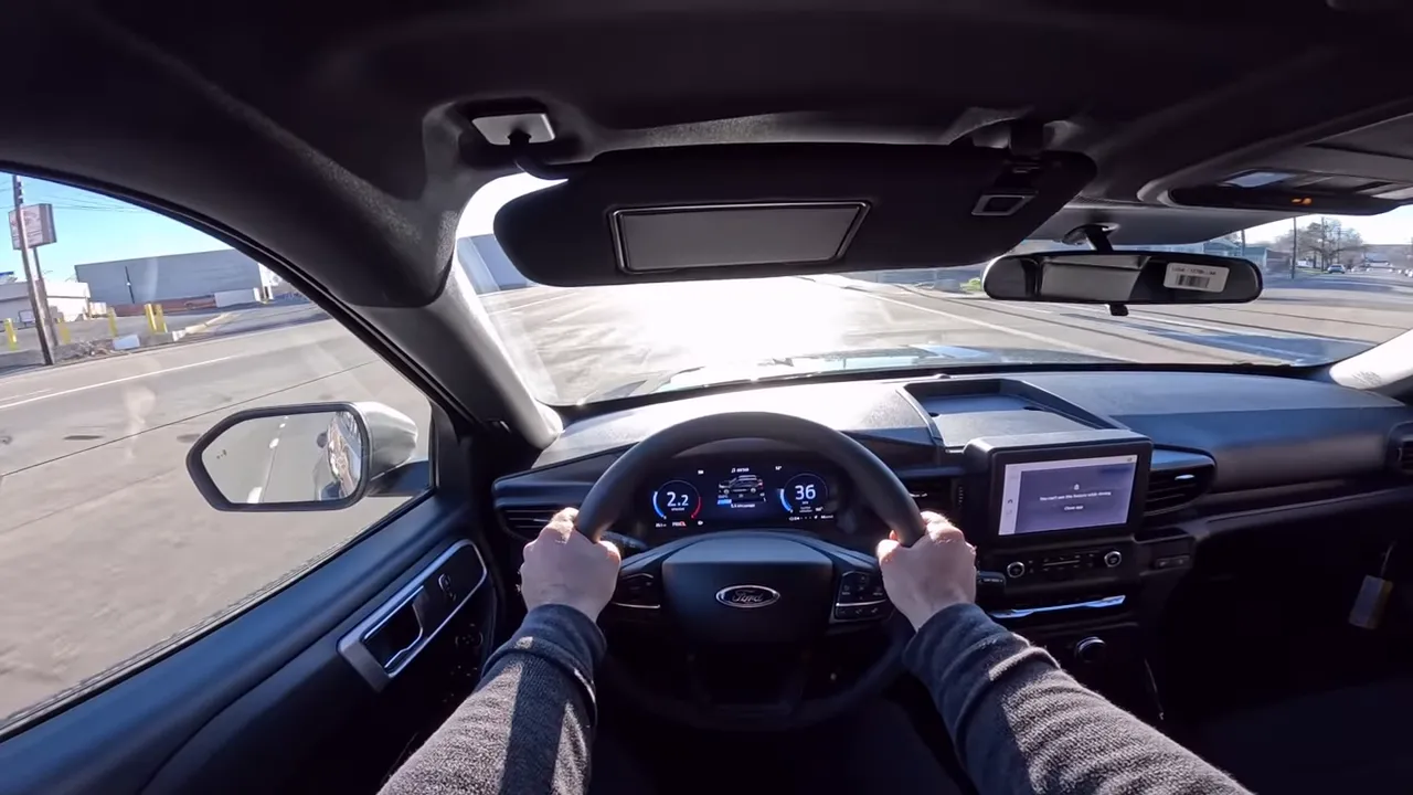 centered driver perspective inside 2026 Ford Explorer Interceptor showing steering wheel, digital gauge cluster and touchscreen
