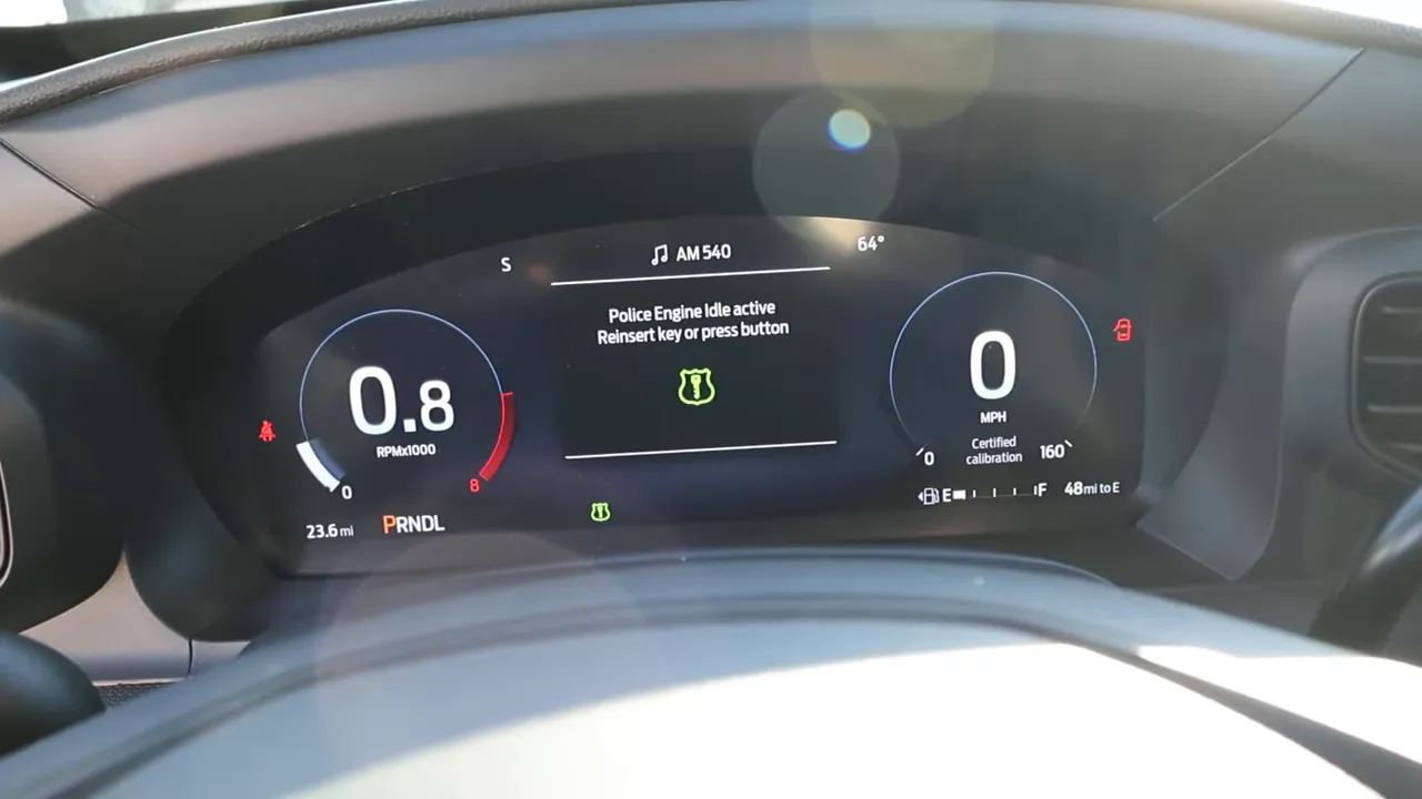 digital instrument cluster displaying message 'Police Engine Idle active — Reinsert key or press button' with tachometer and speedometer