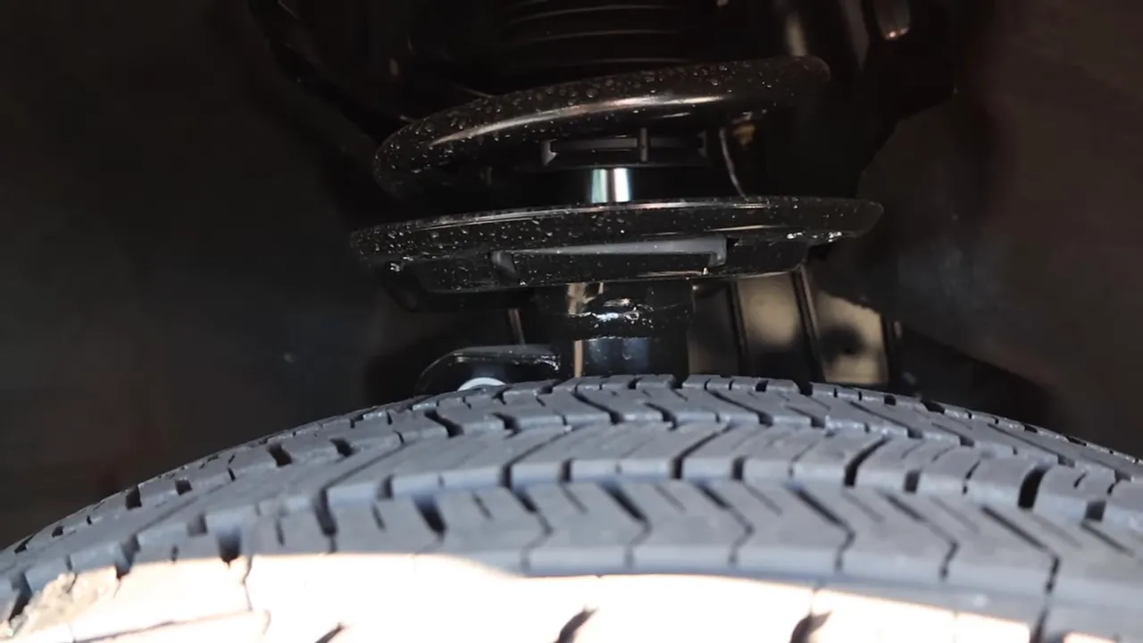 Clear close-up of the coil spring, shock and tire inside the wheel well of the 2026 Ford Explorer Interceptor