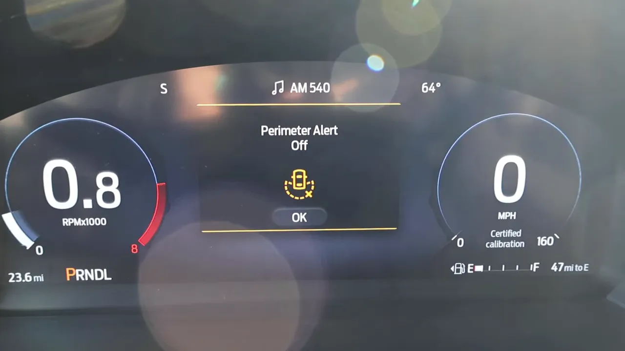 Digital instrument cluster displaying 'Perimeter Alert Off' message with central icon and OK button