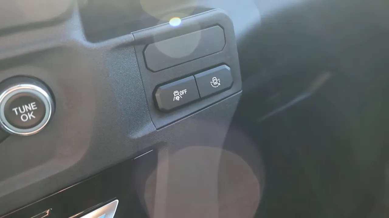 Clear shot of a blank upfit mounting plate and two auxiliary buttons on the Interceptor center console