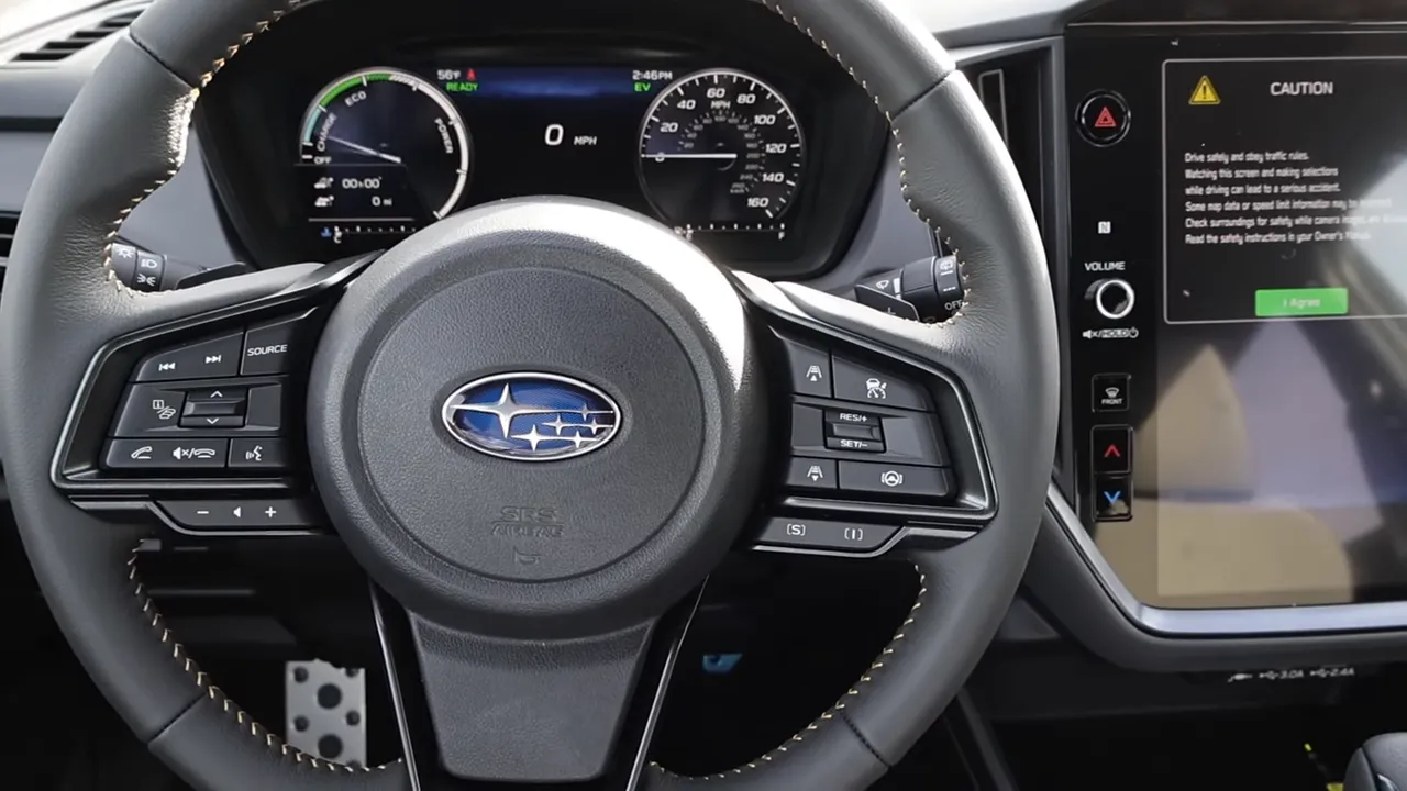 Subaru steering wheel with digital instrument cluster showing 0 mph and an eco/EV gauge.