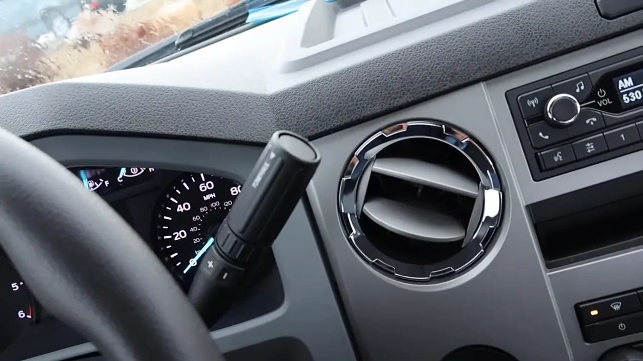 Close-up of Ford F-650 column shifter with part of the instrument cluster and dashboard vent.