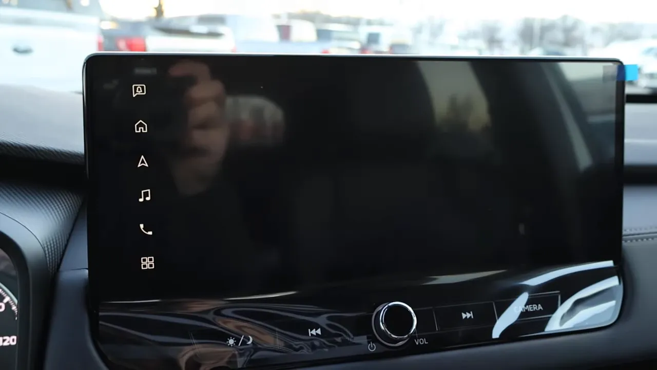 Mitsubishi Outlander infotainment screen with physical volume knob and camera button below the touchscreen