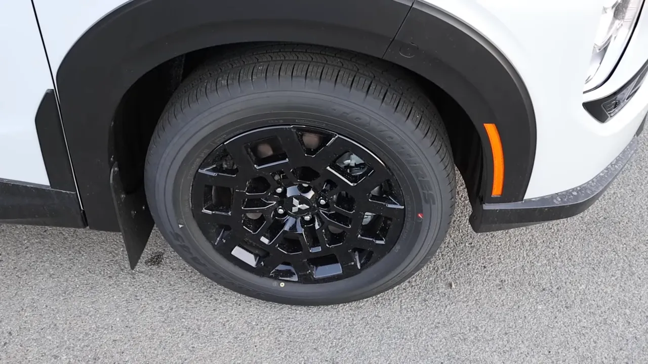 High-clarity close-up of 2026 Mitsubishi Outlander black alloy wheel and 235/60R18 street tire