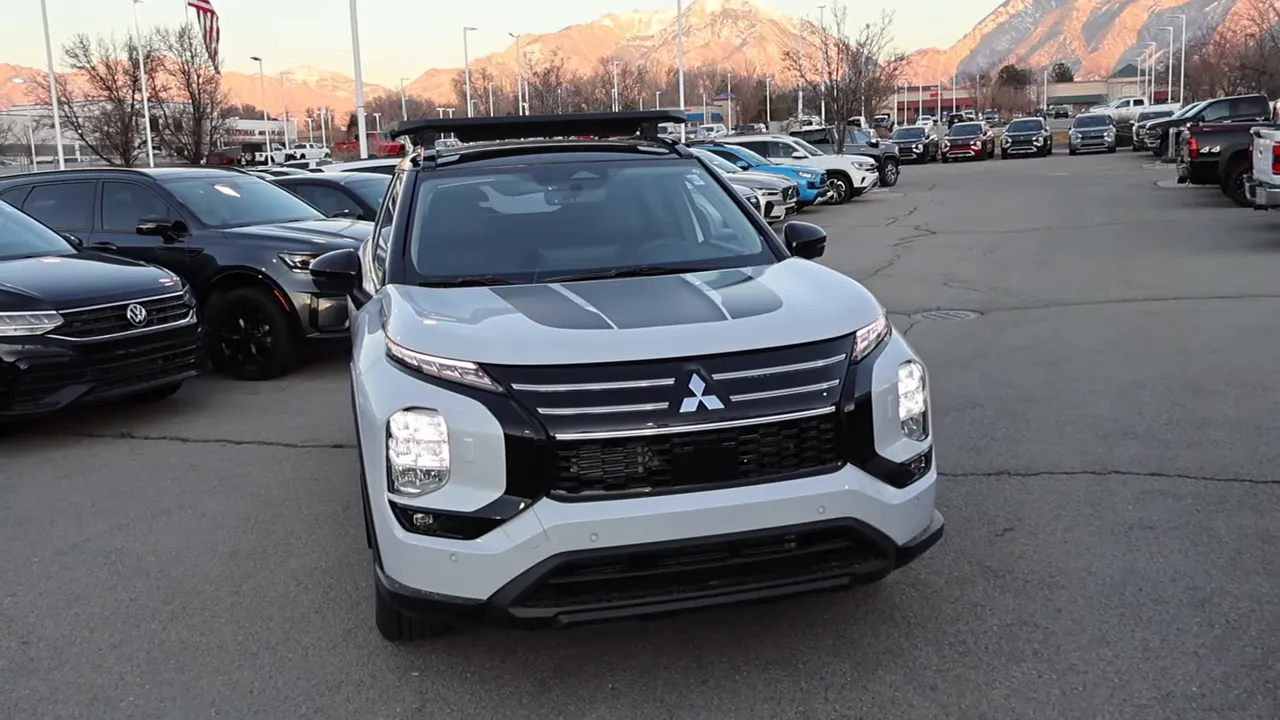 Mitsubishi Outlander Trail Edition front view with hood stripes, split headlights, black trim and roof rack