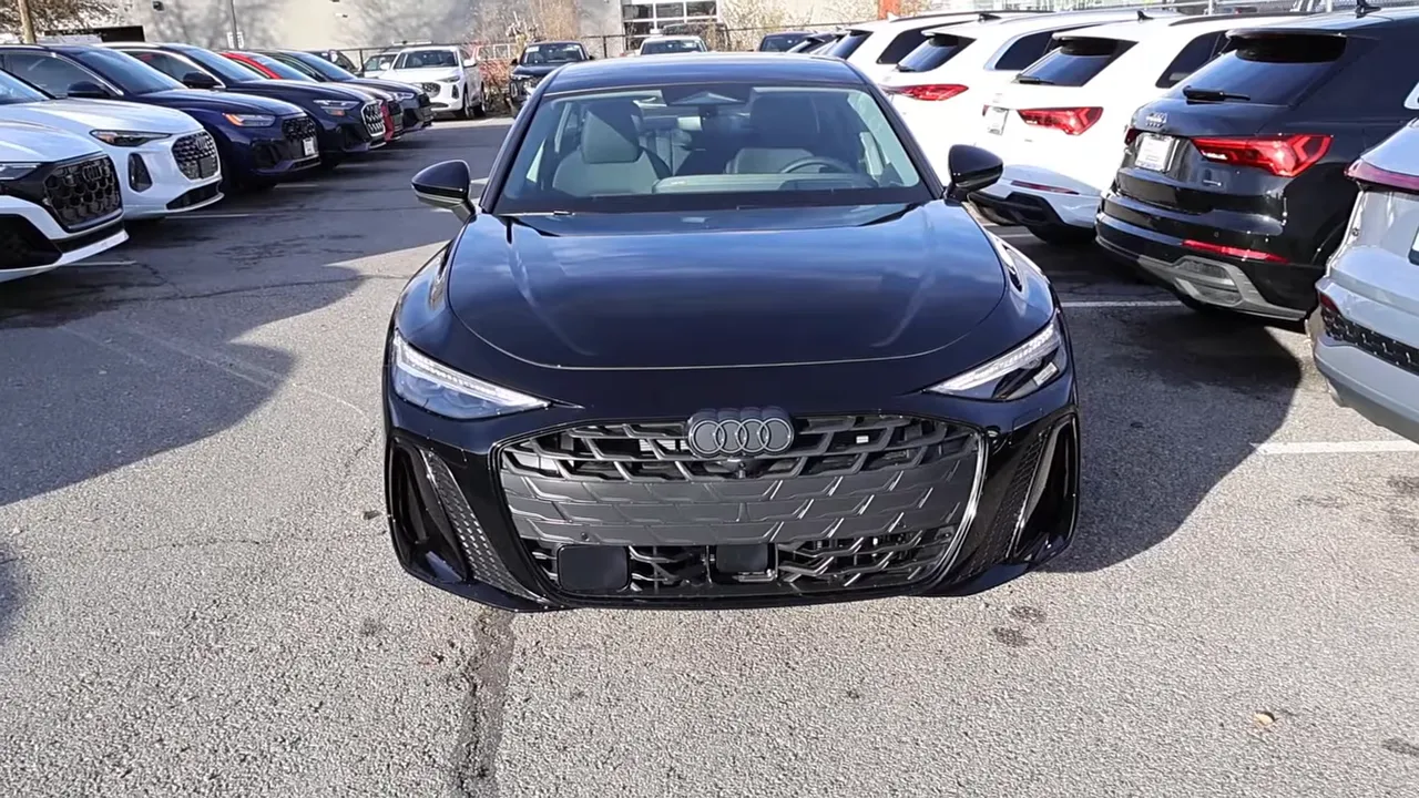2026 Audi A6 full front view highlighting hood creases, LED daytime running lights and aggressive grille in a dealership lot.