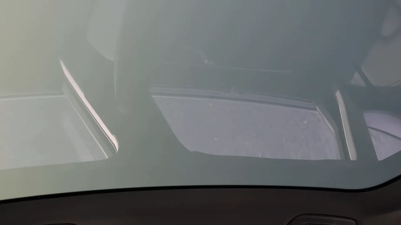 Interior view of the Audi A6 showing the opaque/electrochromic sunroof glass from inside the cabin.