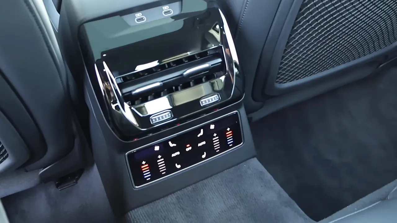 rear center console showing air vents, touch climate controls and USB ports