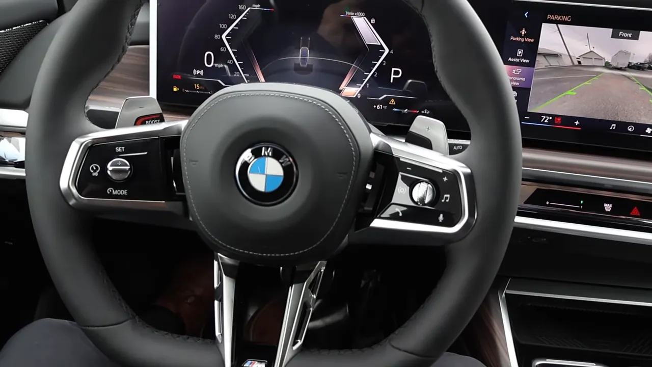 driver viewpoint of BMW steering wheel with digital instrument cluster and wide infotainment display