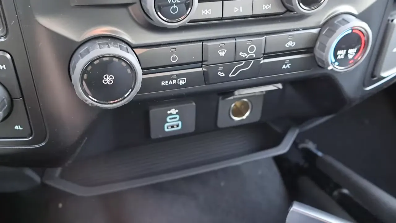 lower center console showing dual USB ports and a 12‑volt power outlet