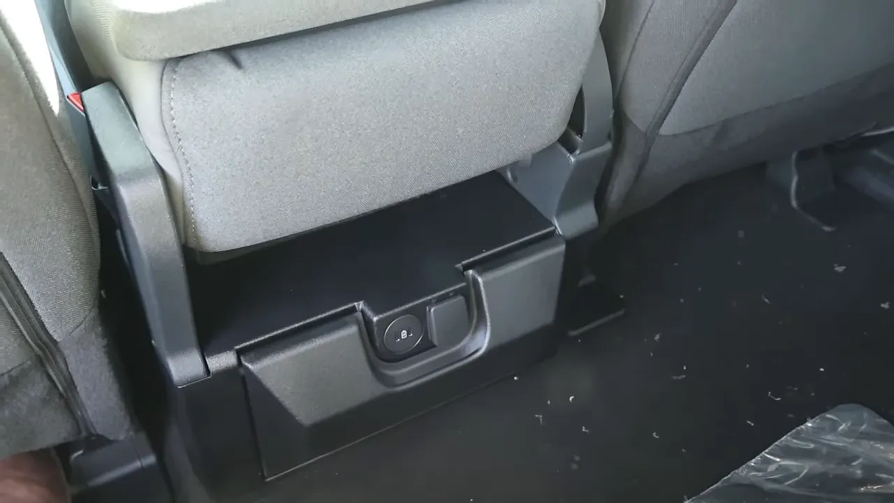 under-seat lower cubby with 12V outlet in the rear of Ford F-350 crew cab
