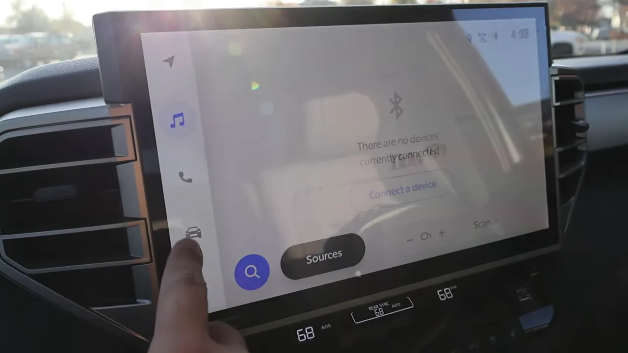 Finger interacting with 2026 Toyota Sequoia large infotainment screen showing connection menu