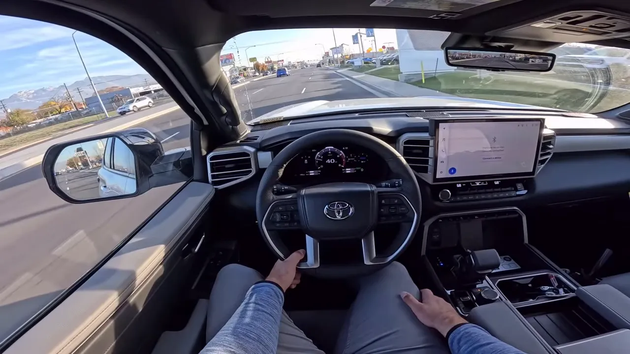 Balanced driver point-of-view interior of 2026 Toyota Sequoia showing steering wheel, 14-inch infotainment screen, and dash (speed ~40 mph)
