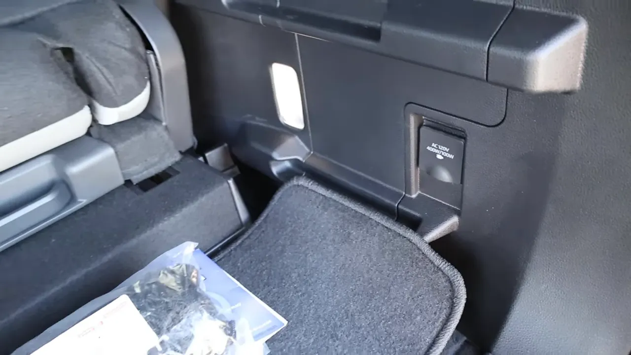 2026 Toyota Sequoia cargo area showing AC 120V power outlet and storage cubby