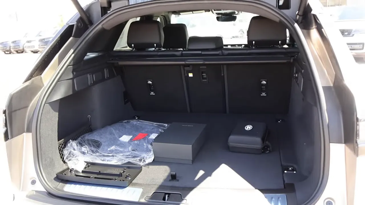 2026 Range Rover Velar open trunk cargo area showing cargo cover, floor space, and small storage items