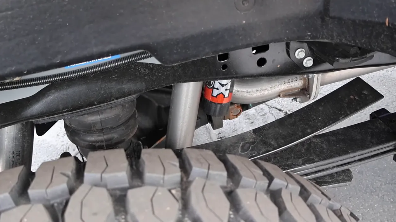 Rear suspension view with Fox remote-reservoir shock, airbag, leaf spring and 35-inch tire