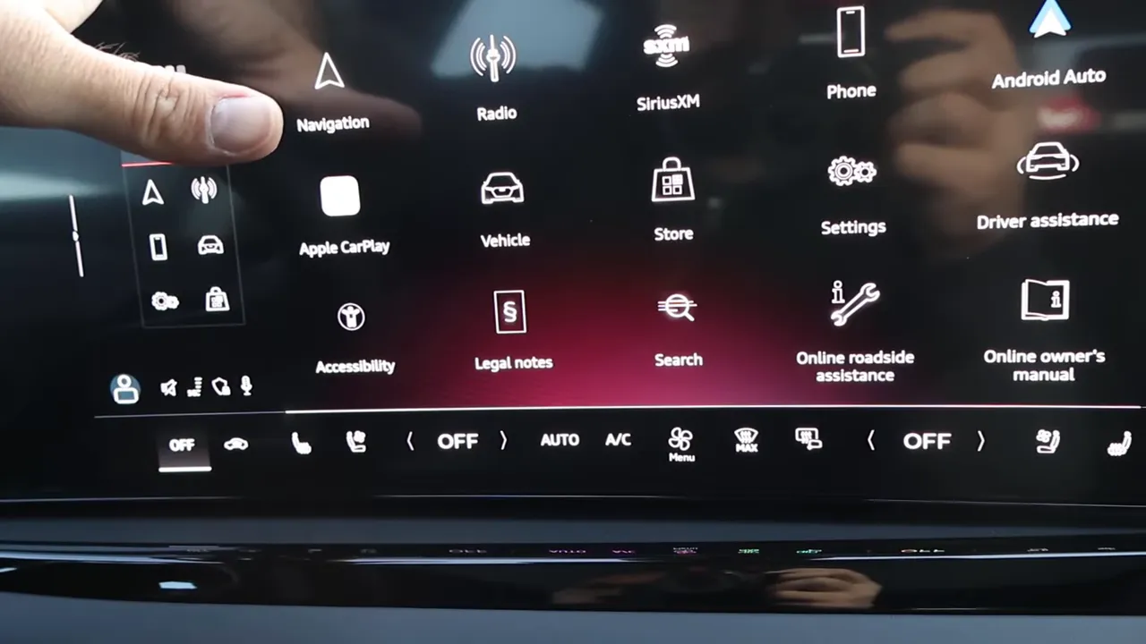 Audi A5 large center touchscreen showing app icons like Apple CarPlay, navigation and a climate shortcut bar beneath
