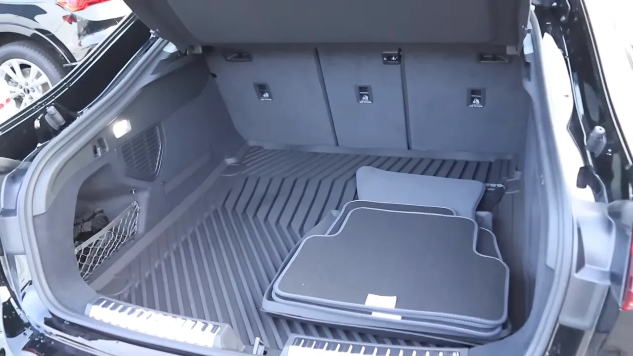 2026 Audi A5 Sportback open trunk showing cargo liner and stacked floor mats