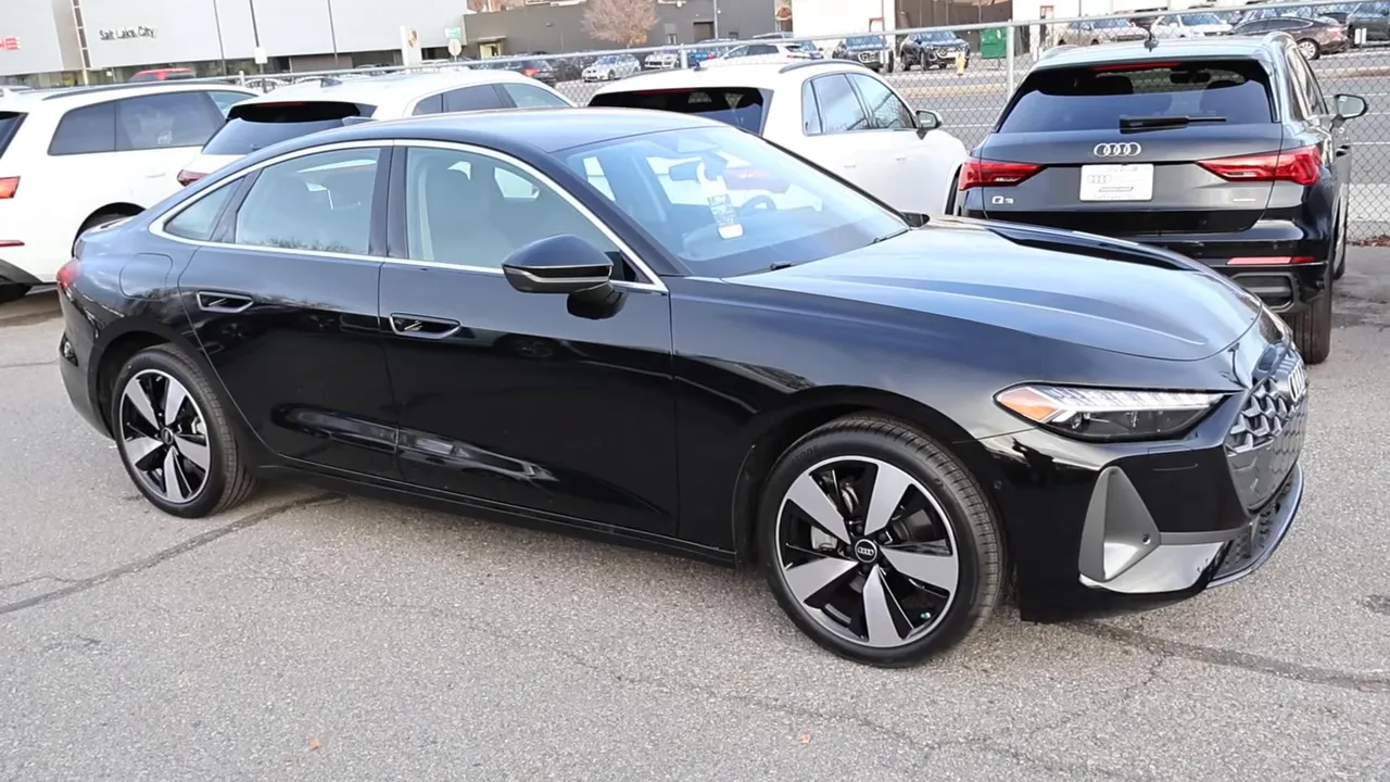 Three-quarter side profile of 2026 Audi A5 showing chrome window trim, body-colored mirror and flush door handles