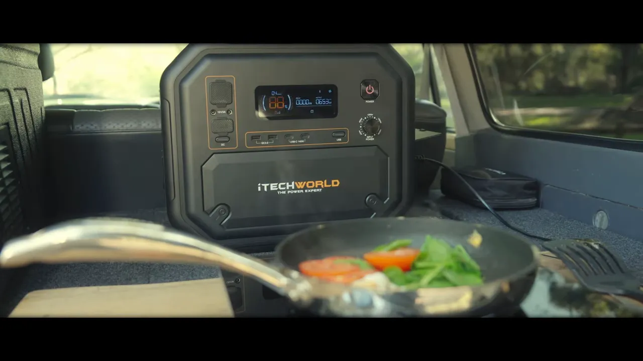 Power station in the rear of a vehicle powering an induction cooktop with a frying pan