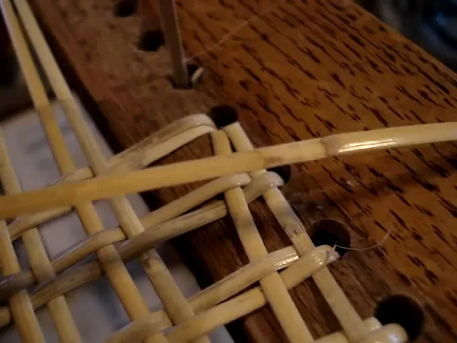 Close-up showing a leaf nodule on a strand of cane used in weaving hole-to-hole cane seats.