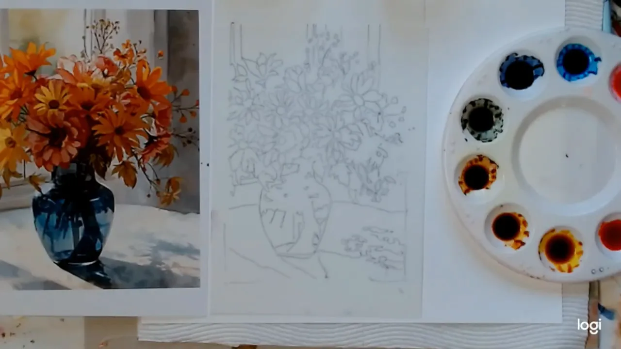 Overhead view showing a printed reference of orange flowers in a blue vase, a pencil sketch on translucent paper, and a round palette with wells of alcohol ink.