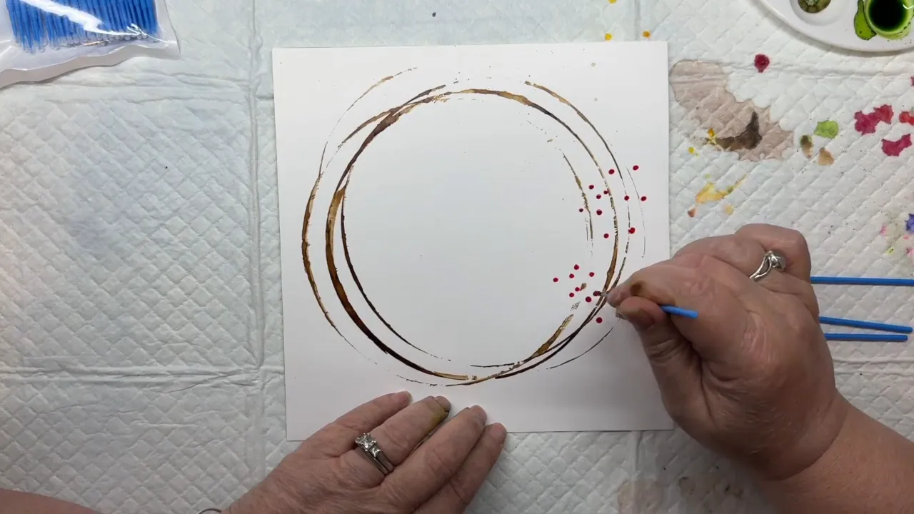 Pink and yellow dots forming the first layer of flowers on the wreath