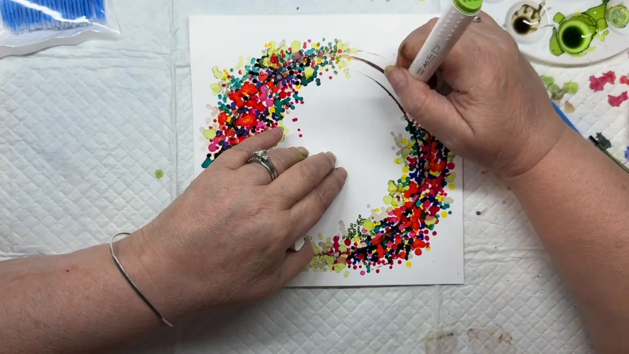 Using a green alcohol ink marker to add connecting lines and details