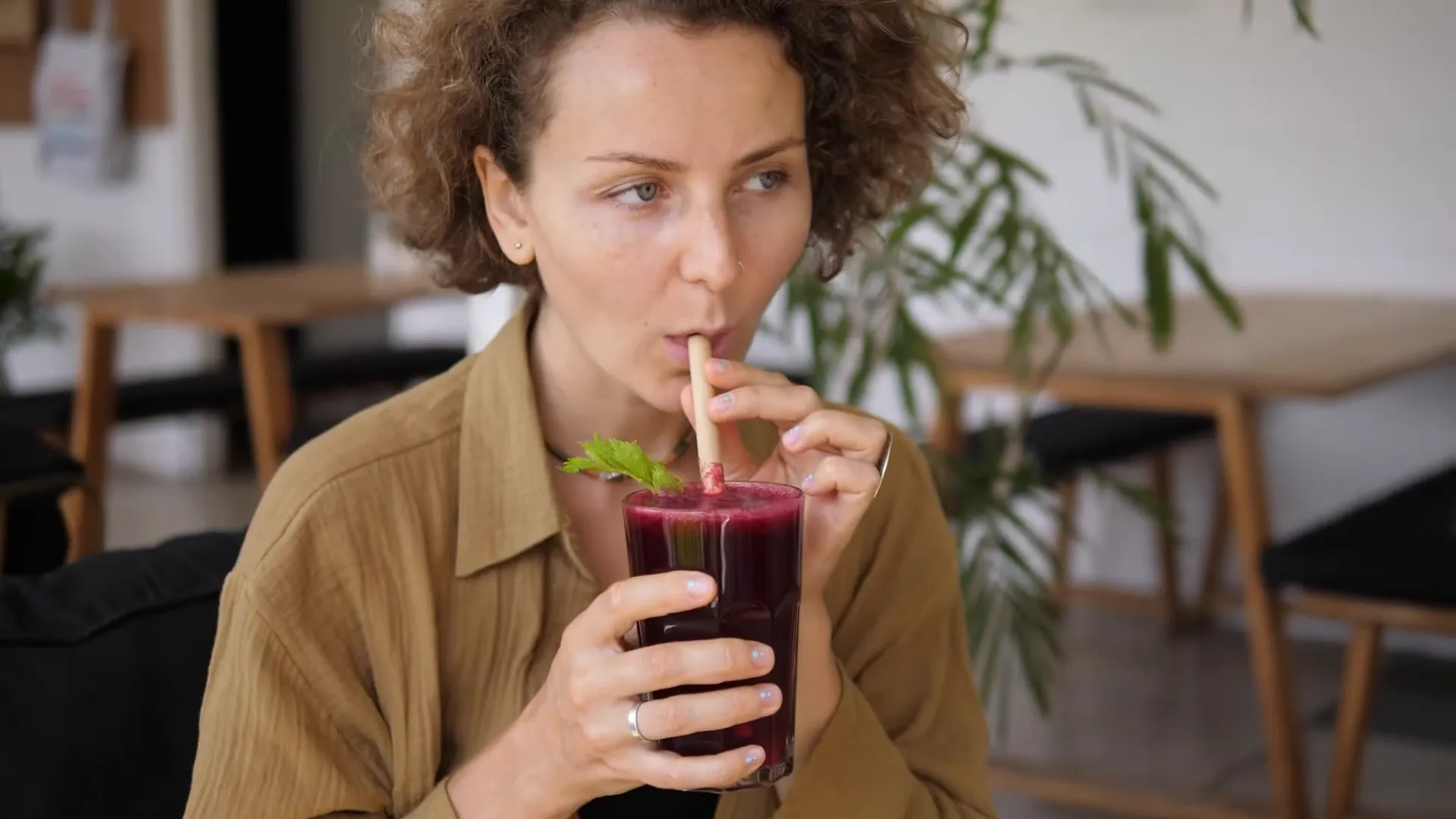 Rachel smiling holding a smoothie